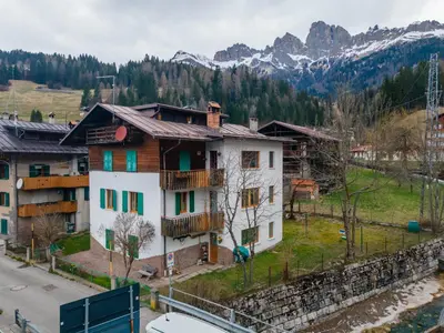 a balcony with a view of a building at Casa Col di Frena in Falcade