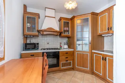 a bedroom with a bed and a dining room at Casa Col di Frena in Falcade