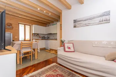 a living room with a couch and a table at Alpe Verde in Falcade