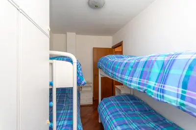 a room with two bunk beds and a closet at Alpe Verde in Falcade