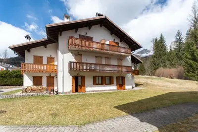 a large house with a balcony on top of it at Alpe Verde in Falcade