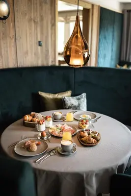 a table with plates of food on it at DER MESNERWIRT - 4 Superior - Meraner Land in Avelengo
