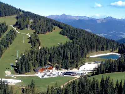 an aerial view of a resort in the mountains at Hotel Jú Furcia in San Vigilio Di Marebbe