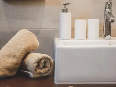 a bathroom with a sink and a towel on a counter at Hotel Turmwies in Tirolo