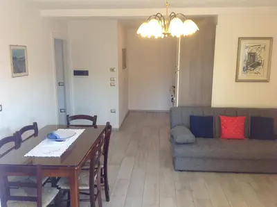 a living room with a table and a couch at Villa in Val di Fiemme in Cavalese
