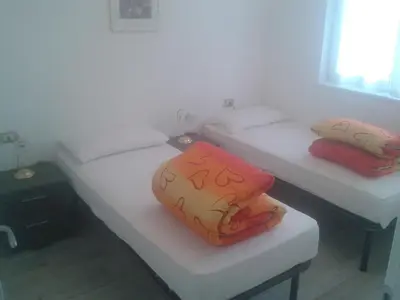 two beds with pillows on them in a room at Villa in Val di Fiemme in Cavalese