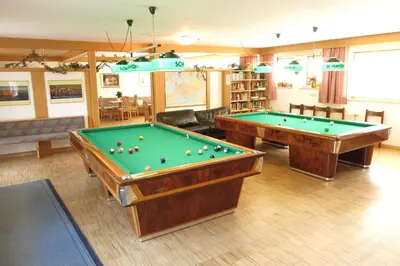 a living room with two pool tables in it at Apartments Residence Montana in Rasun di Sopra