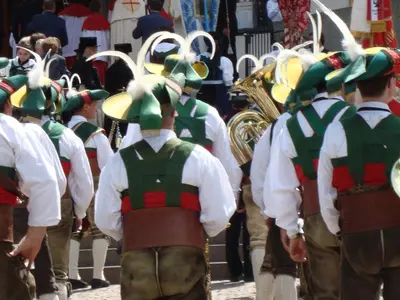 a group of men in uniform in a parade at Apartments Residence Montana in Rasun di Sopra