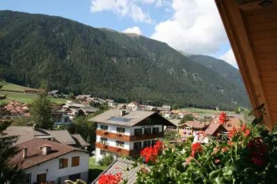 a view of a town in the mountains at Apartments Residence Montana in Rasun di Sopra