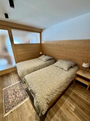 a bedroom with two beds and a window at Apartment Enrosadira in Taibon