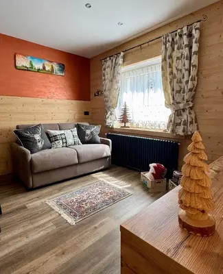 a living room with a couch and a window at Apartment Enrosadira in Taibon