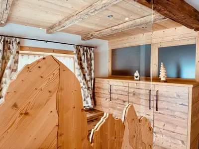 a wooden room with a tv and a wooden door at Apartment Enrosadira in Taibon