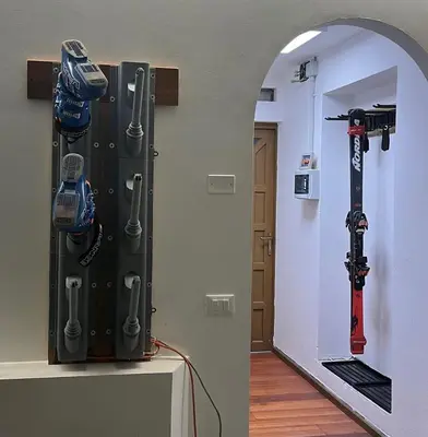 a room with a rack of ski equipment on the wall at Apartment Enrosadira in Taibon