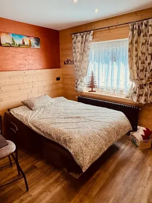 a bedroom with a bed and a window at Apartment Enrosadira in Taibon