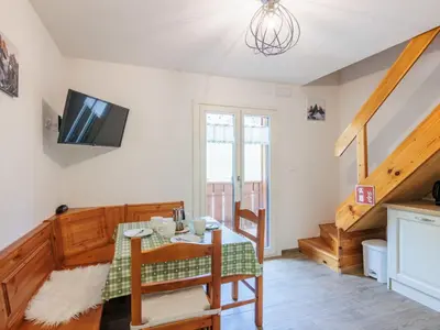 a kitchen with white cabinets and a staircase at Apartment Penia 2-3 by Interhome in Canazei