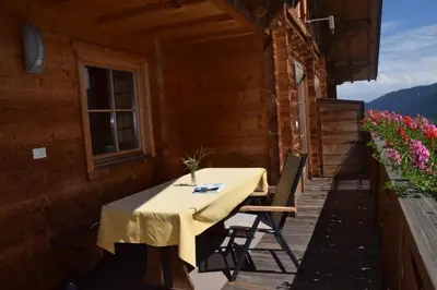 a table on the porch of a house at Ortlerhof im Ultental - Urlaub auf dem Bauernhof in Ultimo