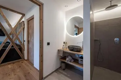 a bathroom with a sink and a mirror at Steindlgut - Weinberg Chalets in Brixen