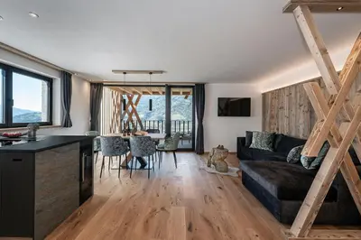 a living room with a couch and a table at Steindlgut - Weinberg Chalets in Brixen