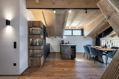 a kitchen and dining room with a table and chairs at Steindlgut - Weinberg Chalets in Brixen