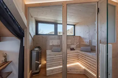 a sauna in a wooden house with a window at Steindlgut - Weinberg Chalets in Brixen