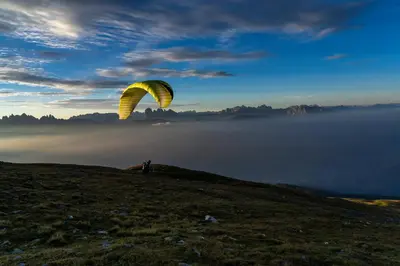 a person standing on top of a hill with a parachute at Schienhof in Chiusa