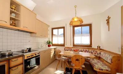 a kitchen with a table and a couch in it at Schienhof in Chiusa