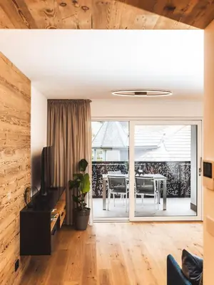 a kitchen with black cabinets and a stove at Paradeis Apartments in Mühlbach