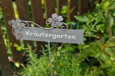 a sign for a garden with flowers on it at Kircherhof in Marlengo