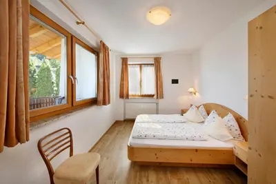 a small bedroom with a bed and a window at Kircherhof in Marlengo