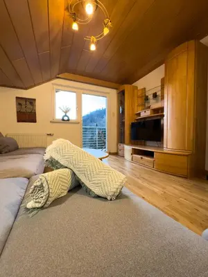 a living room with a couch with a blanket on the floor at Apartment Rosengarten - Rosenheim Apartments in Tires