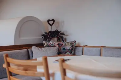 a person sitting on a couch with a heart on the wall at Apartment Steinbach in Schenna