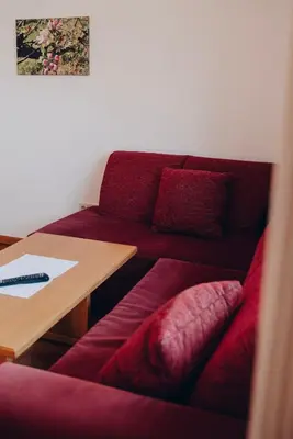 a living room with a couch and a table at Apartment Steinbach in Schenna
