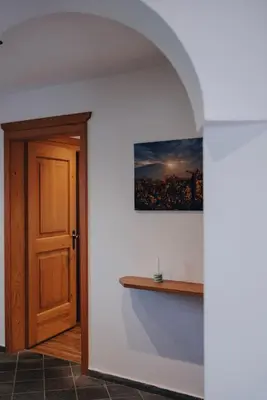 an open door in a room with a picture on the wall at Apartment Steinbach in Schenna