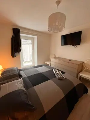 a bedroom with a bed and a tv on the wall at Abete Bianco in Mezzano