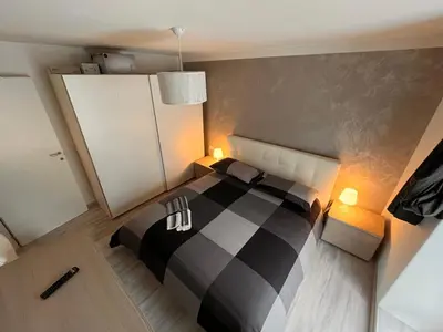 a bedroom with a black and white bed and two chairs at Abete Bianco in Mezzano