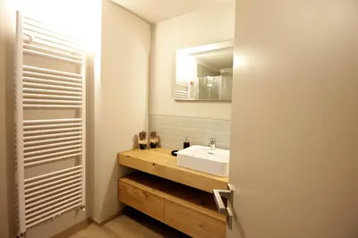 a bathroom with a white sink and a mirror at VILLA CAVAZZAL - 2 camere, 2 bagni, garage Dolomiti Affitti in Cavalese