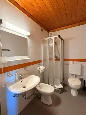 a bathroom with a sink and a toilet and a shower at Hotel Pietralba in Madonna di Petralba