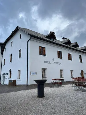 a white building with a table in front of it at Hotel Pietralba in Madonna di Petralba