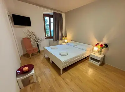 a bedroom with a large white bed and a table at Hotel Pietralba in Madonna di Petralba