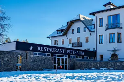 a building with a sign that readsrestaurant perrine at Hotel Pietralba in Madonna di Petralba
