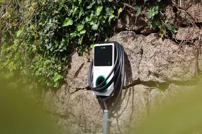 a cell phone is attached to a wall next to water at Garni Praidlerhof in Tirolo