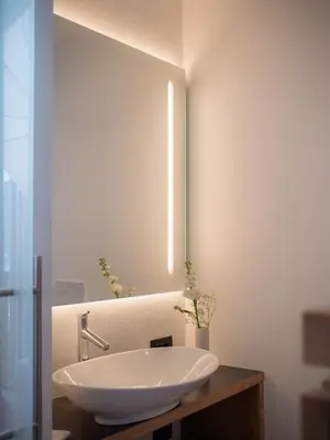 a bathroom with a white sink and a mirror at Garni Praidlerhof in Tirolo