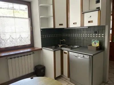 a kitchen with a sink and a dishwasher at Casa Leo By Gonewlocation in Cavalese