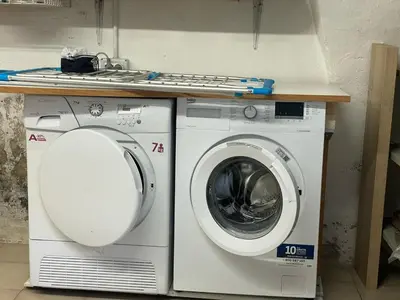 a washing machine and a washer under a counter at Casa Leo By Gonewlocation in Cavalese