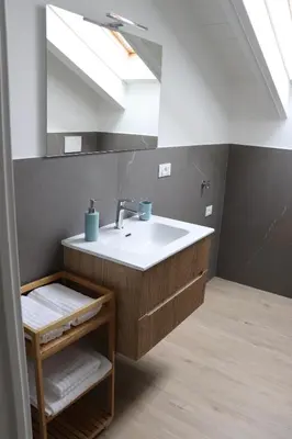 a bathroom with a sink and a mirror at Casa Dusinei Blue & Green in Cles