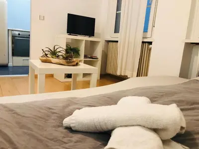 a bedroom with a bed with a towel on it at Vintler Apartments in Bolzano