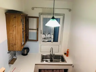 a kitchen with a sink and a window at Vintler Apartments in Bolzano