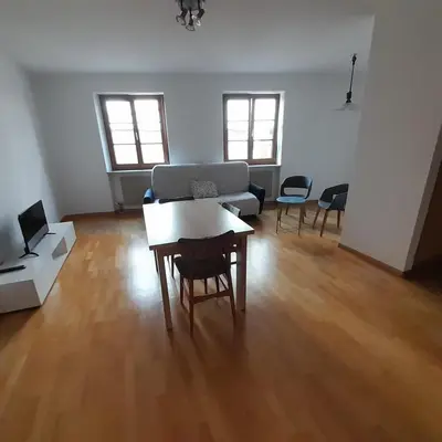 a living room with a table and a laptop in it at Vintler Apartments in Bolzano