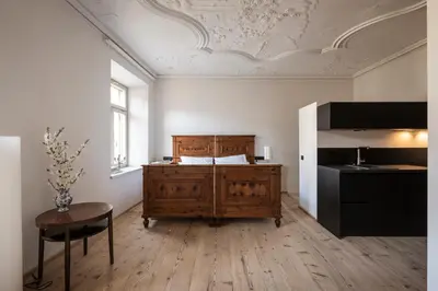 a table and chair in a room with a window at Ansitz Thierburg Suites in Merano