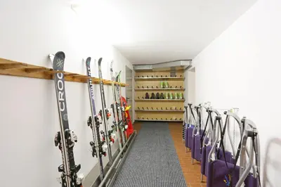 a row of skis are lined up in a room at Pension Alpenhof B&B in Colle Isarco